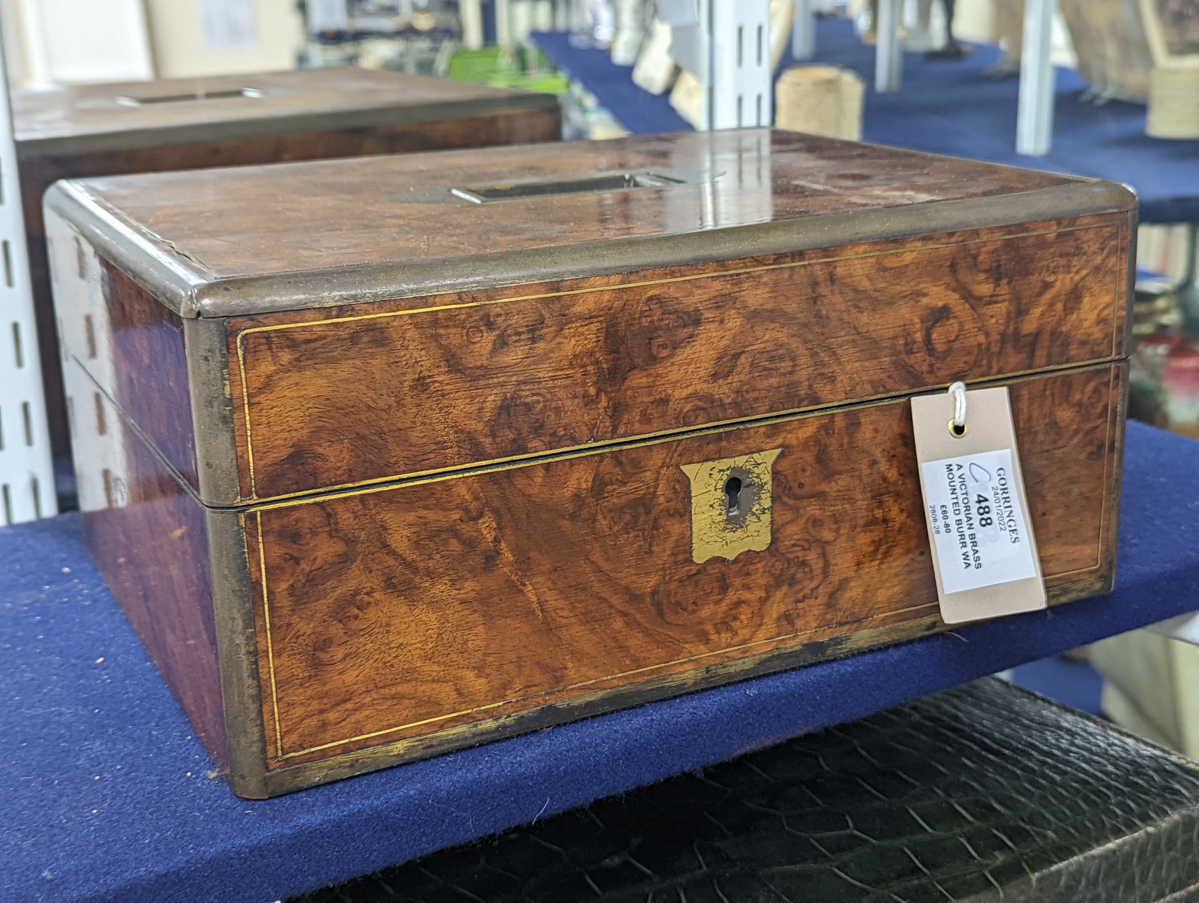 A Victorian brass mounted burr walnut toilet box, fitted with glass jars with electroplated tops, Width 30 cms. Ivory mounted items included
